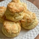 A white plate with a pile of homemade buttermilk biscuits