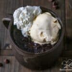 Brownie in a mug with ice cream and whipped cream