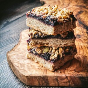 3 walnut blueberry shortbread cookie bars stacked on top of each other