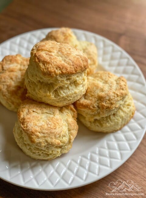A white plate with a pile of homemade buttermilk biscuits