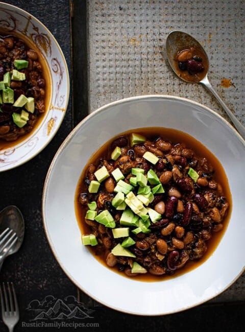 Two white bowls with 3 bean sweet potato chili