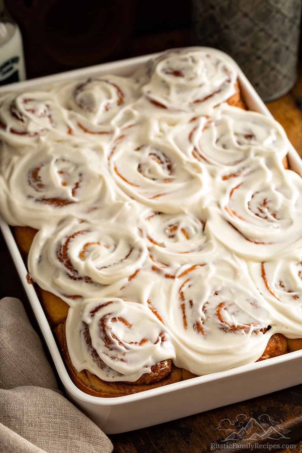 Frosted cinnamon rolls in a baking dish