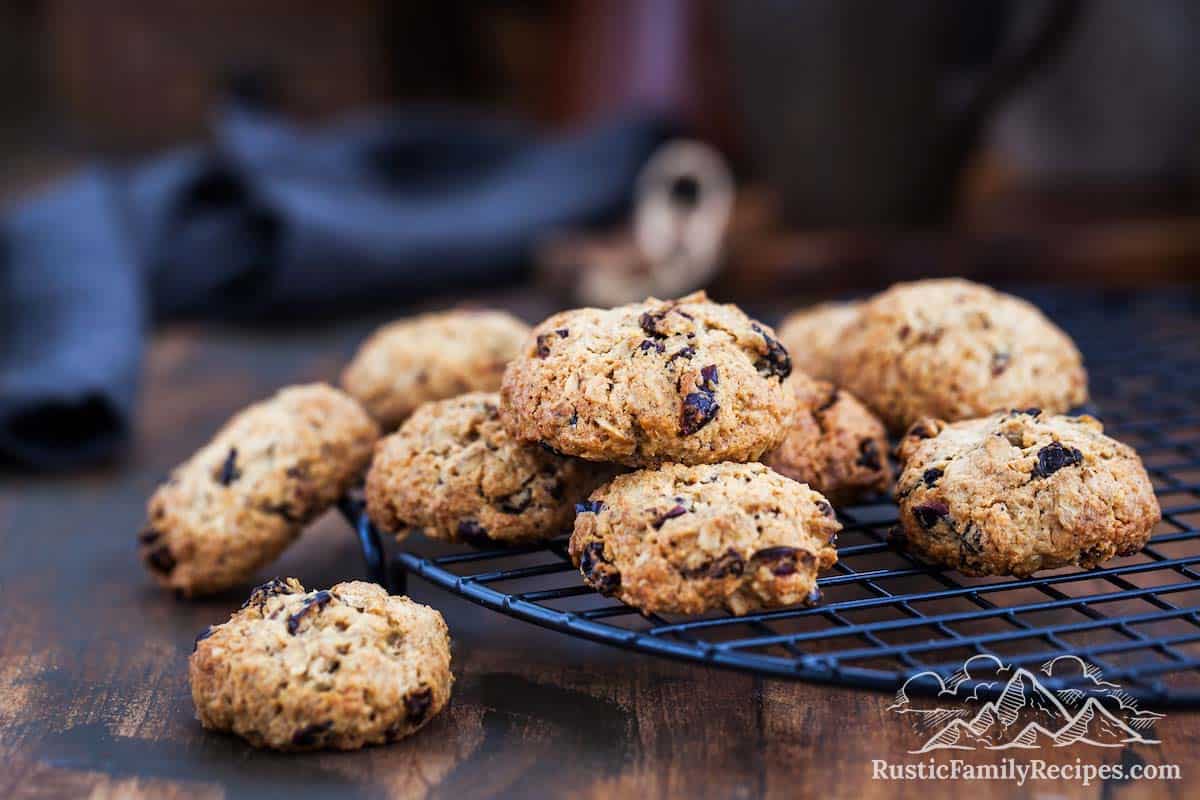 A pile of oatmeal raisin cookies on a cooling rack
