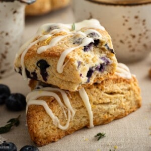 two stacked blueberry scones with a bit taken out of the top scone