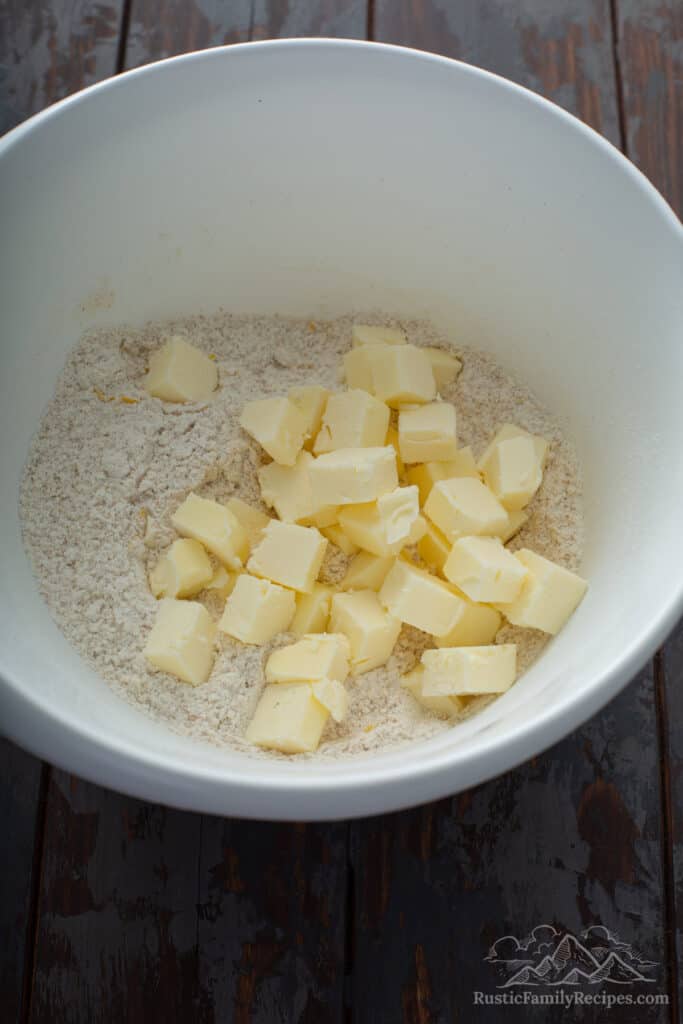 Butter cubes being added to dry ingredients.