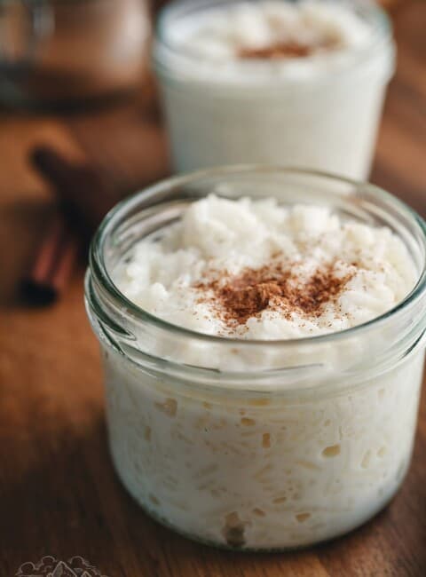 Rice pudding in mason jars topped with cinnamon