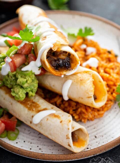 Plate of black bean flautas with Mexican rice.