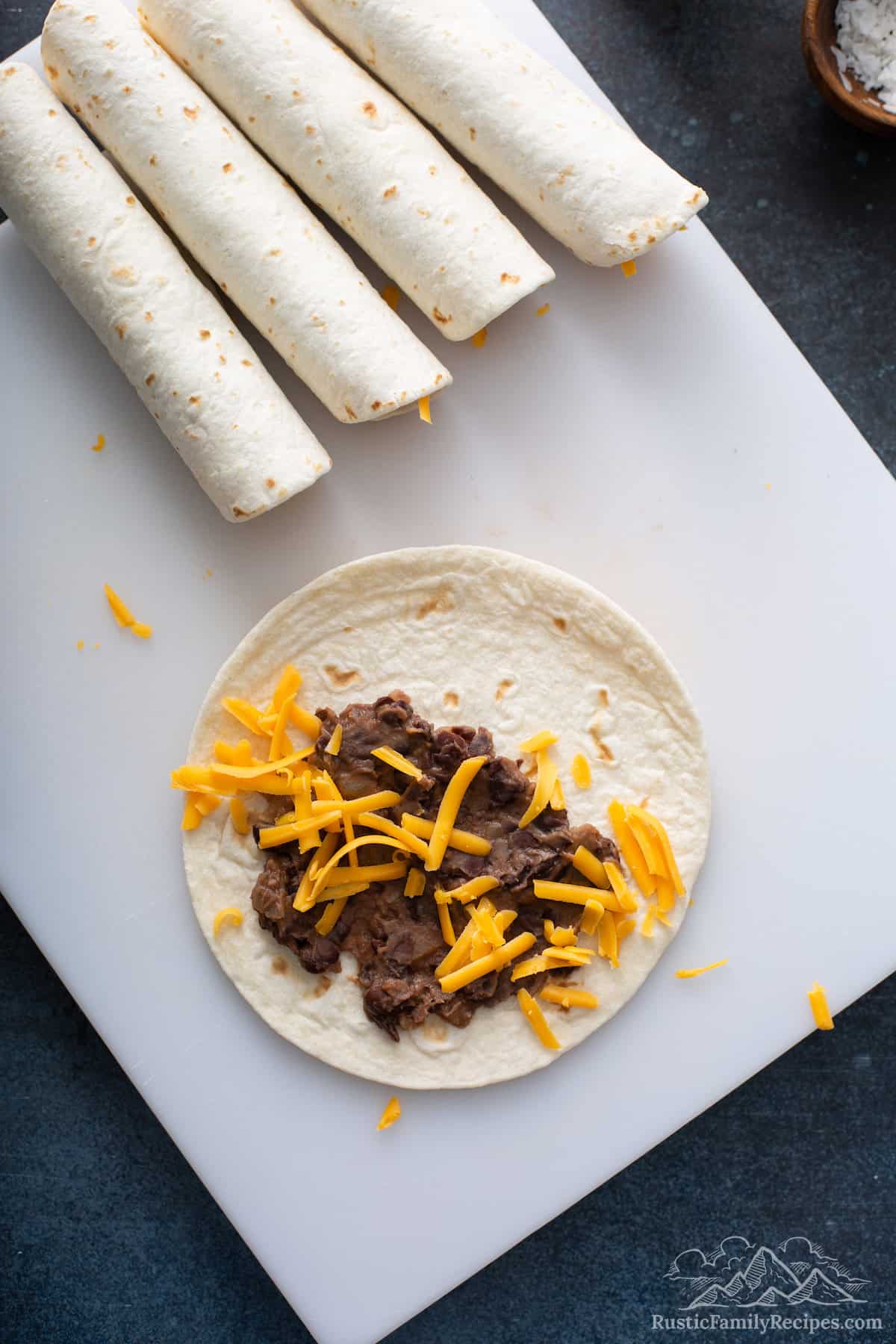 Flour tortillas with mashed beans and cheese.
