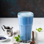A tall glass with blue matcha latte