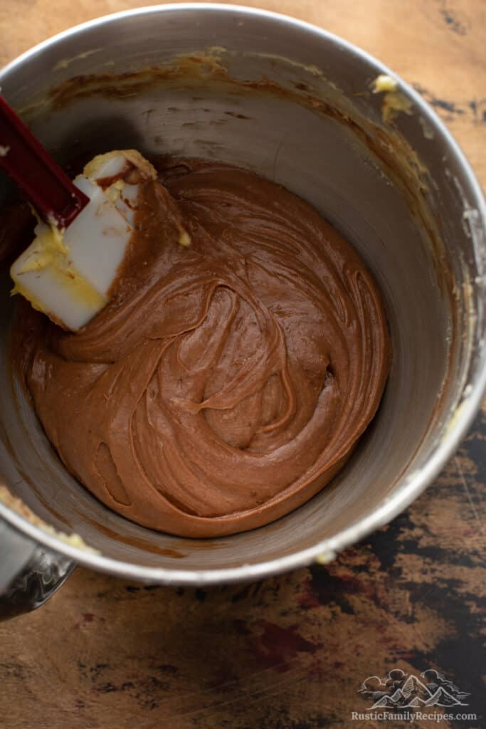Chocolate batter for a marble cake in a mixer bowl.
