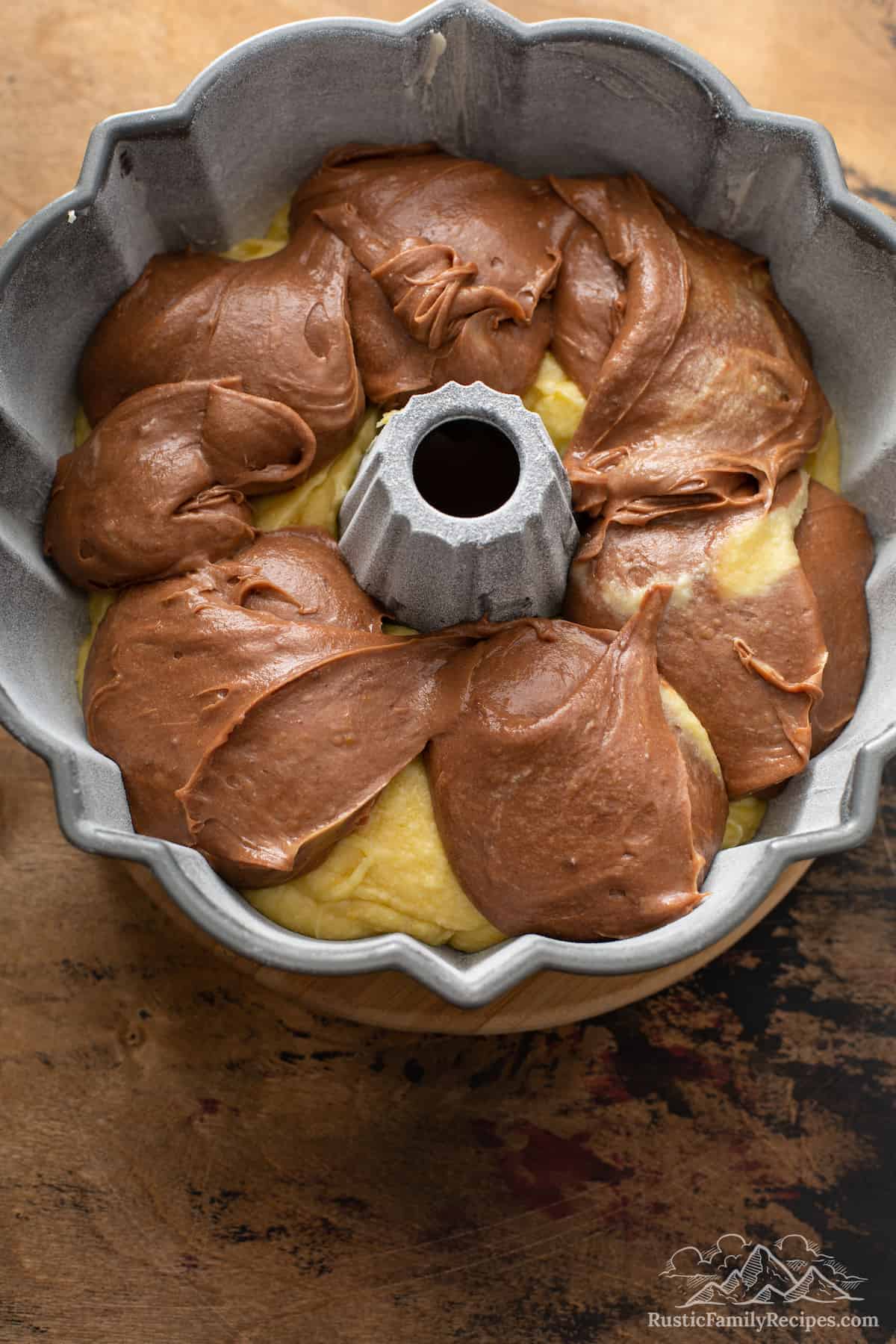 Chocolate and vanilla batter in a bundt pan.