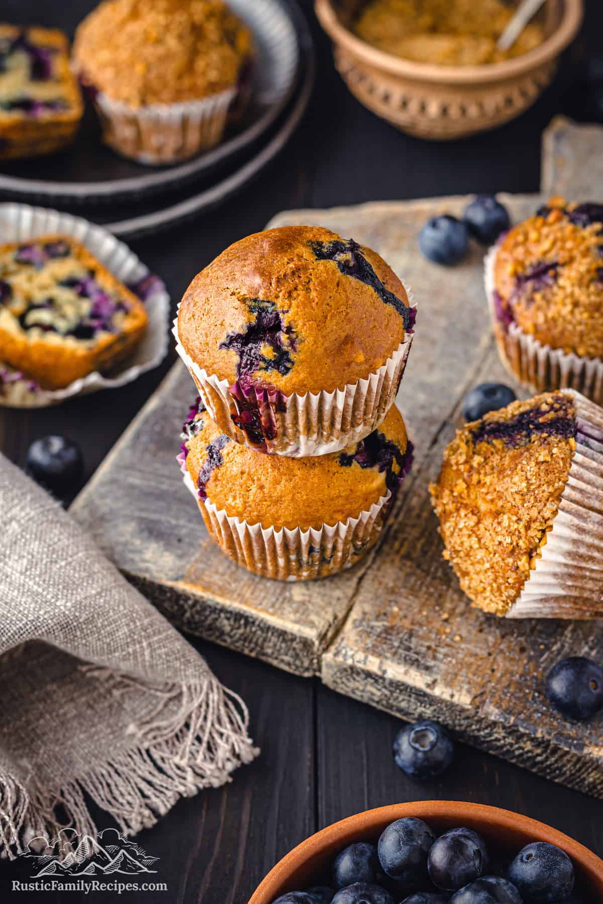 4 sourdough blueberry muffins on a wood cutting board