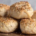 a pile of homemade sourdough everything bagels