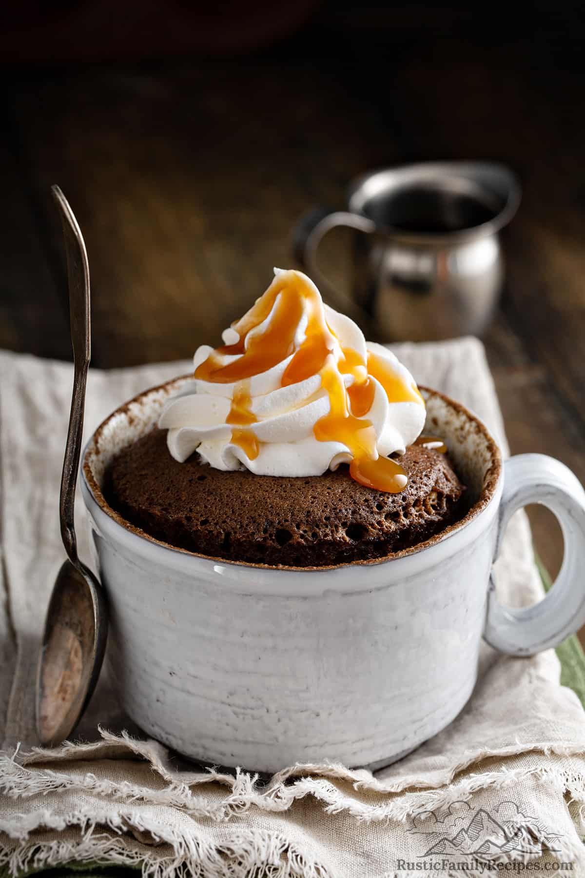 A nutella mug cake in a cup with whipped cream