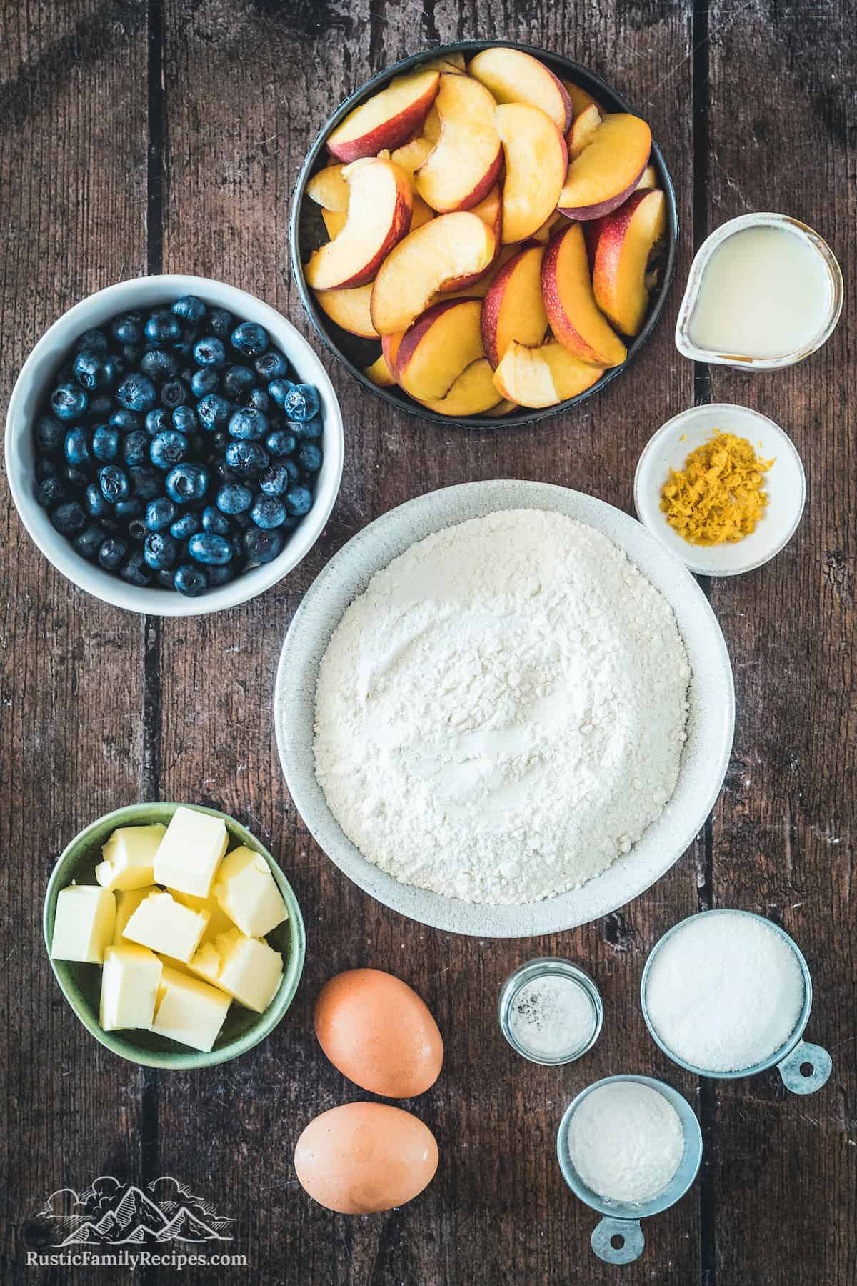 Ingredients for blueberry peach cobbler in bowls