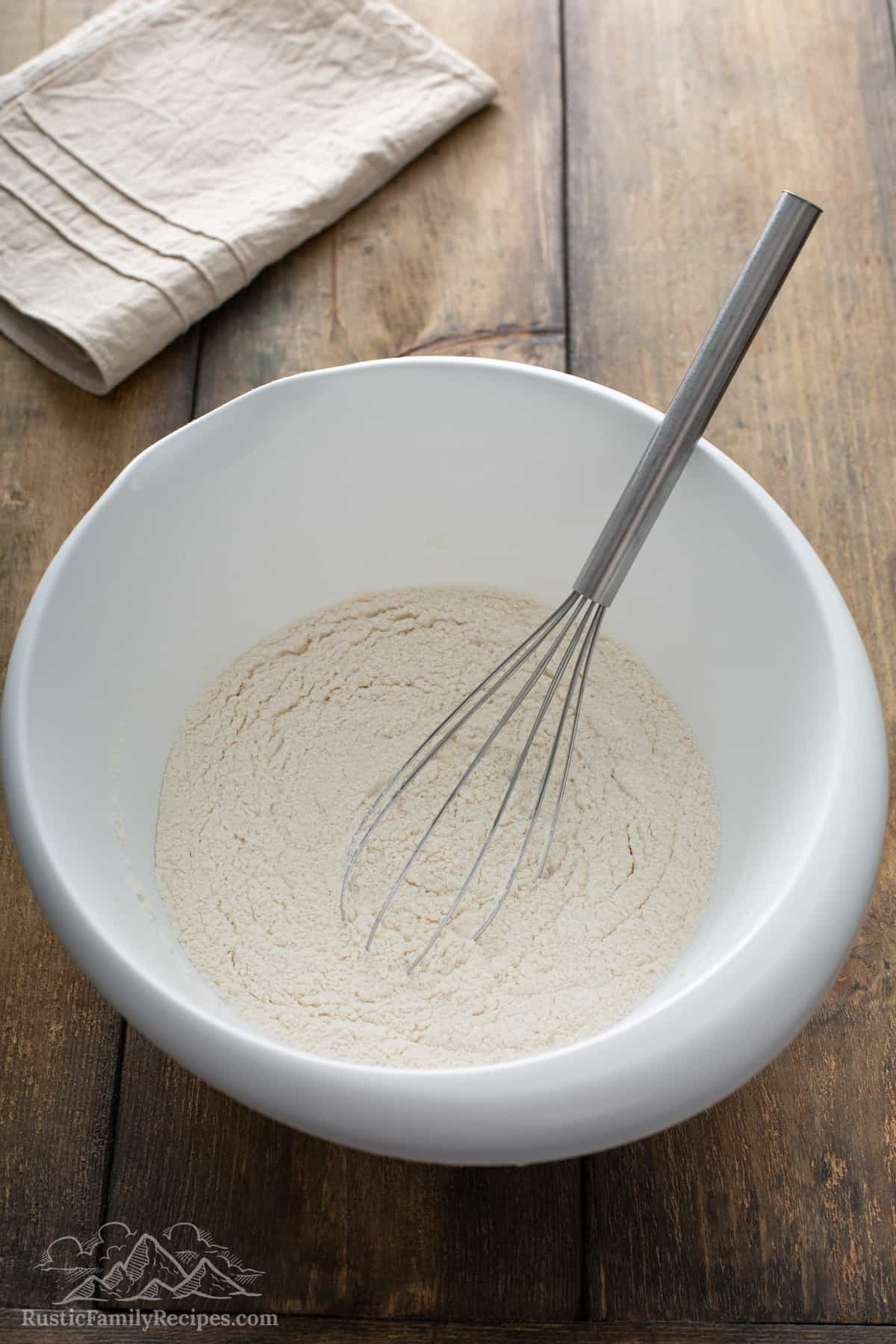 Dry pancake ingredients in a white bowl