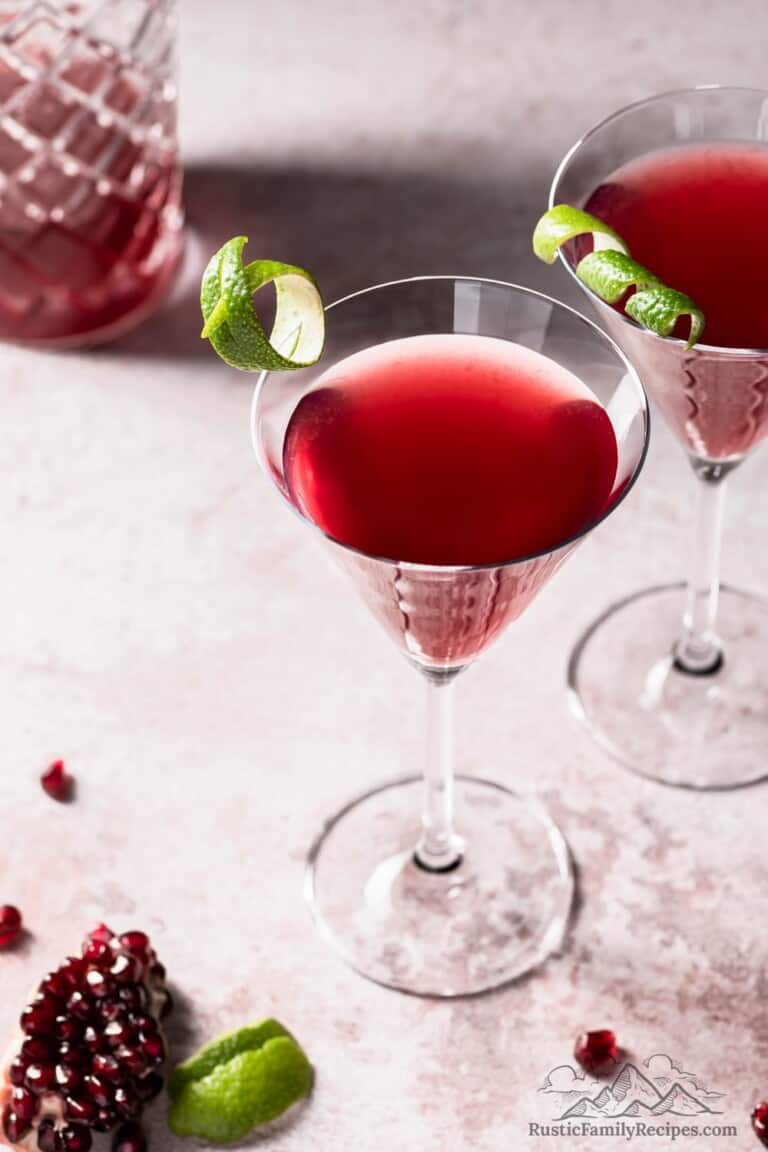 A martini glass with pomegranate maple cosmopolitan