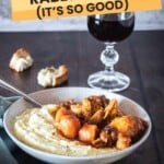 A bowl of rabbit stew with mashed potatoes.