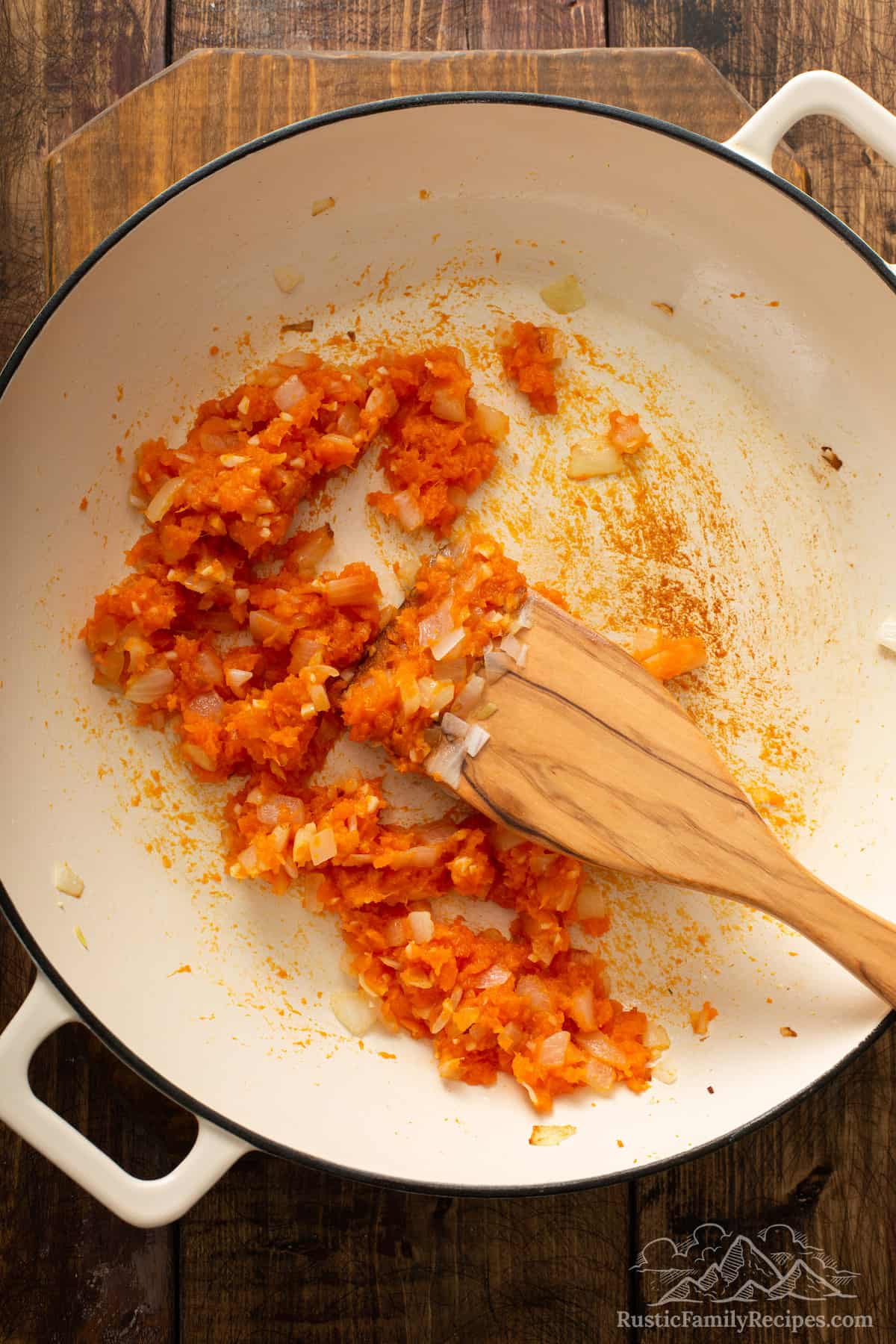 Sweet potatoes and onions sauteed in a pan