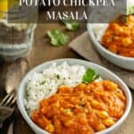 Two bowls of Instant Pot Sweet Potato Chickpea Masala with rice, a fork, and water.
