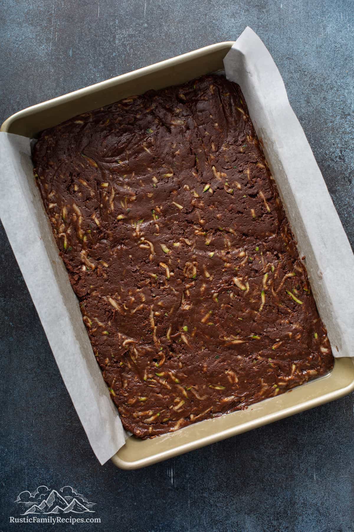 Unbaked zucchini brownie batter in a pan