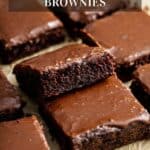 A stack of zucchini brownies on parchment paper