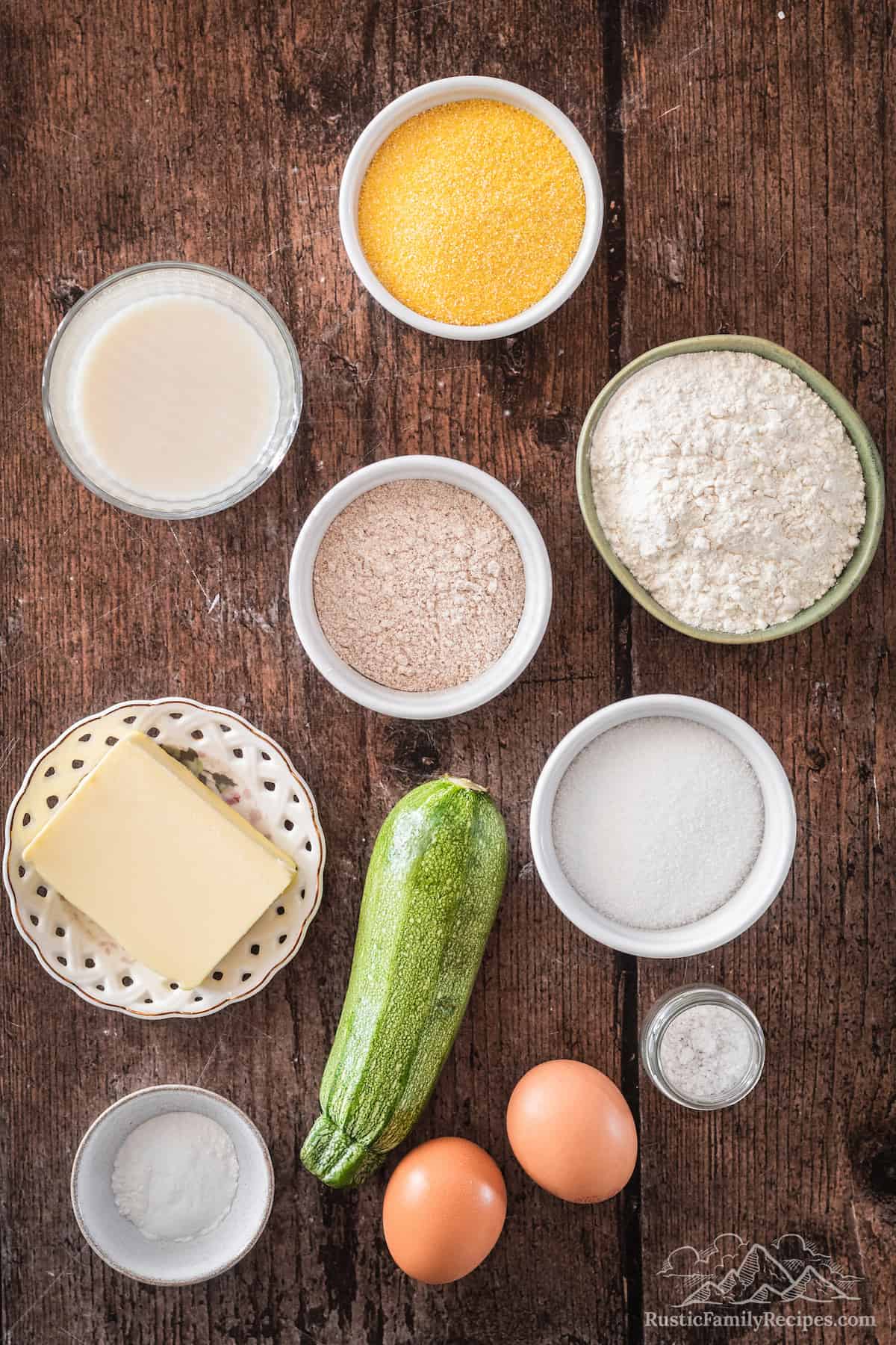 Everything you need for Zucchini Cornbread: butter, eggs, buttermilk, zucchini, all-purpose flour, whole wheat flour, sugar, baking powder, salt, baking soda, cornmeal.