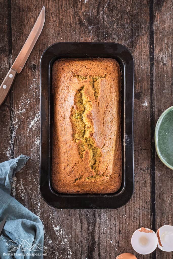 The prepared pan with the cooked golden zucchini cornbread.