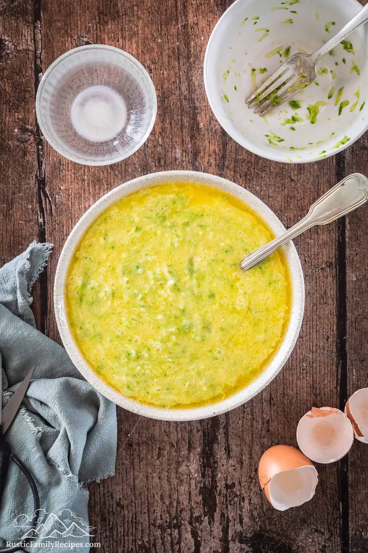 A bowl full of the zucchini and buttermilk mixture