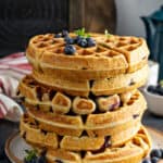 A stack of Blueberry Buttermilk Waffles on a plate.