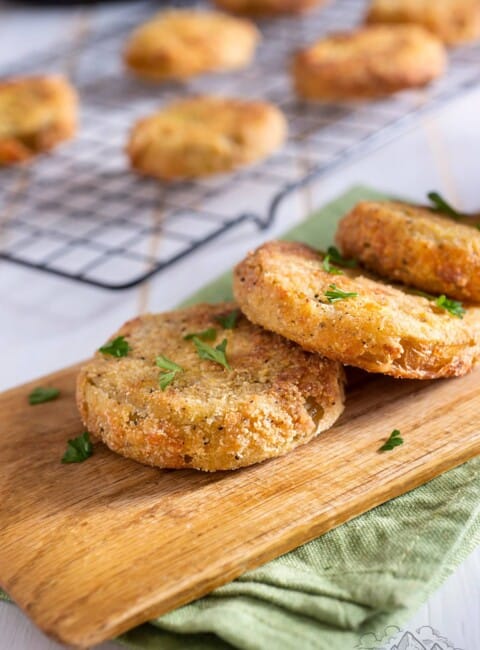 Fried green tomatoes on a wood cutting board