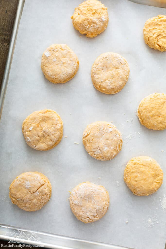 Unbaked Sweet Potato Buttermilk Biscuits on parchment-lined baking sheet