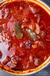 Beef and bay leaves cooking in a broth