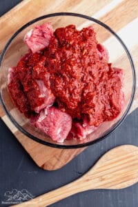 Beef cubes in a bowl with marinade