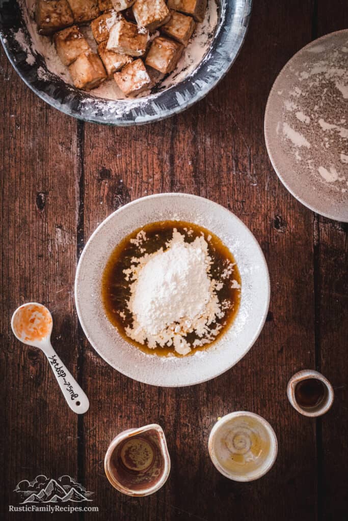 Cornstarch being mixed into Orange Tofu sauce