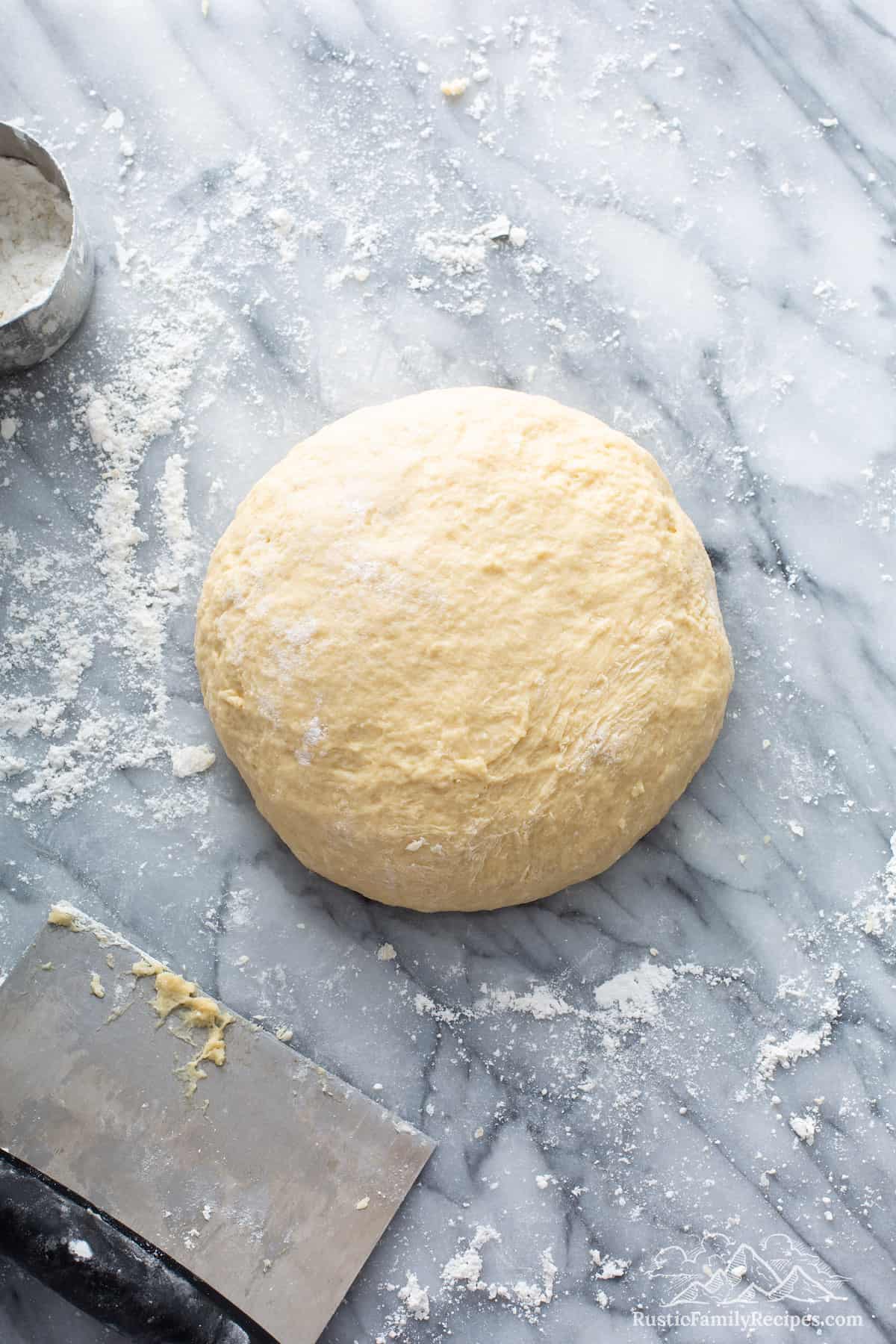 Mexican morning bun dough on marble slab