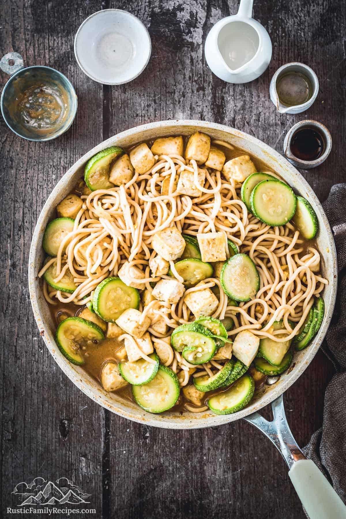 Overhead shot of Peanut Noodles with tofu and zucchini in skillet