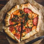 Rustic tomato galette with a slice taken out