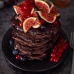 A tall stack of chocolate pancakes