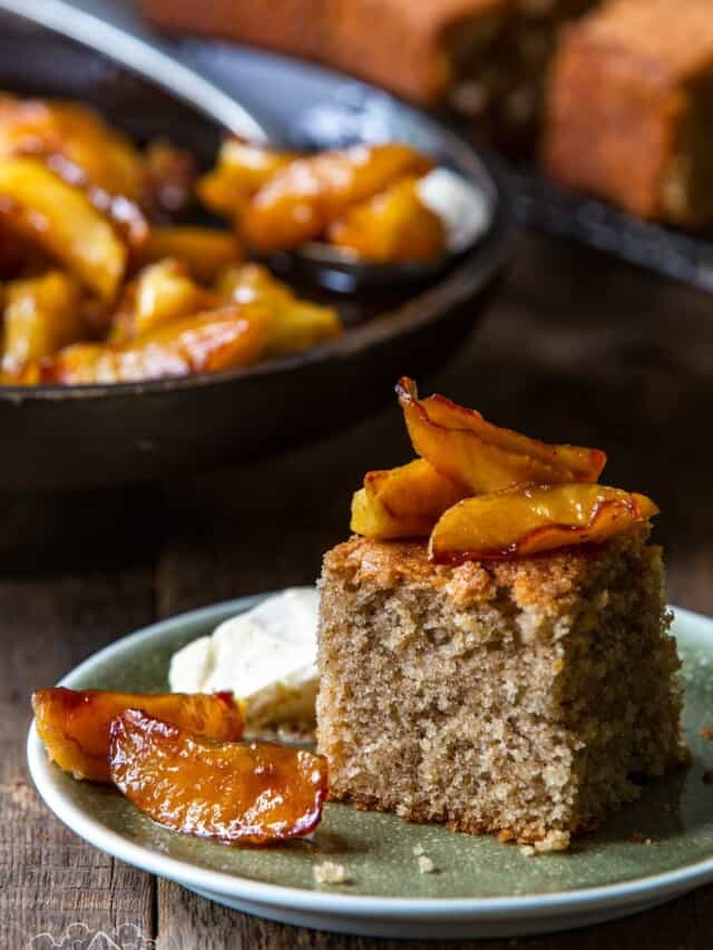 Spice Cake With Caramelized Apples on plate with skillet in background