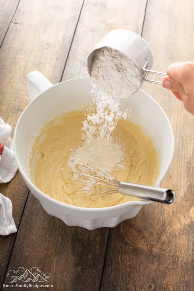 Pouring flour into Honey Vanilla Challah dough