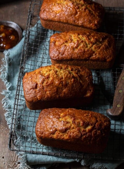 Mini apple zucchini breads cooling on a wire wrack