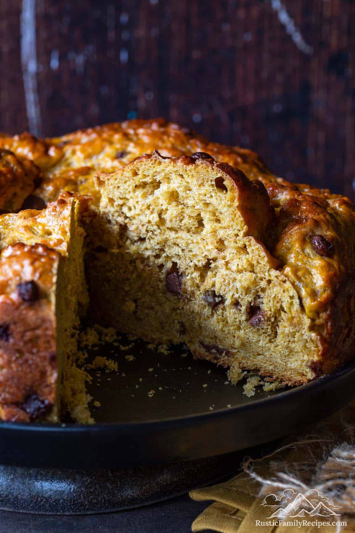 Pumpkin chocolate chip bread loaf with large slice removed
