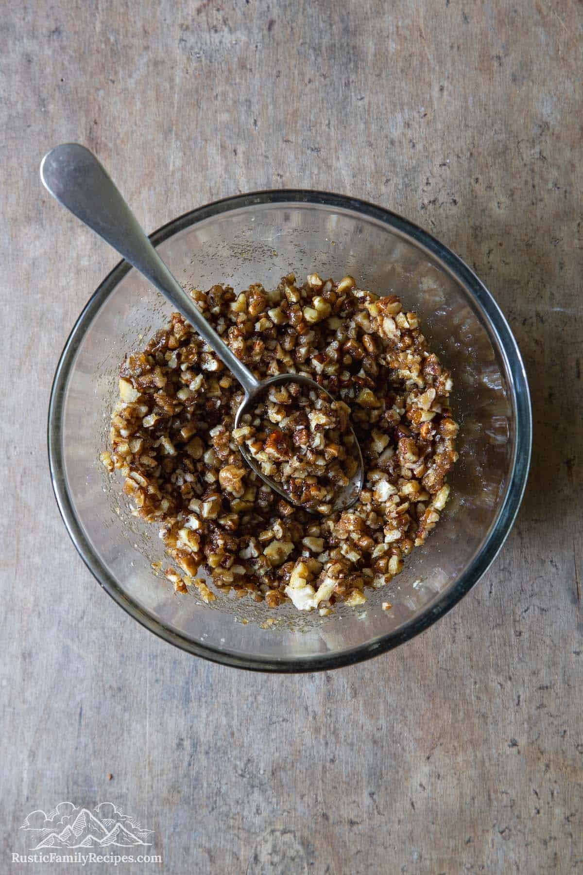 Overhead view of coffee cake filling in glass bowl with spoon