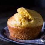 A cornbread muffin on a blue plate