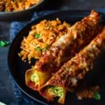 Avocado enchiladas on a plate with mexican rice