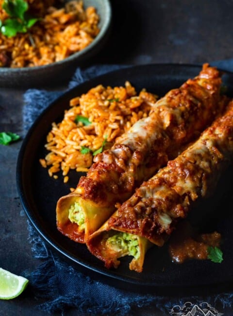 Avocado enchiladas on a plate with mexican rice