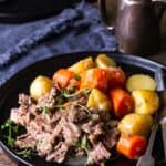 Instant Pot Pot Roast on a plate with carrots and potatoes