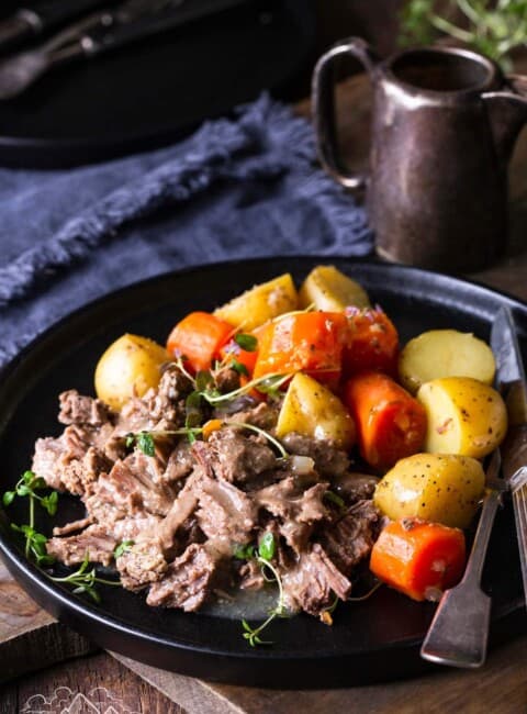 Instant Pot Pot Roast on a plate with carrots and potatoes