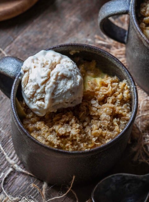 Apple crumble in a mug with ice cream